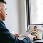 Man working on a laptop and tools, symbolizing business ideas for men to earn from their skills
