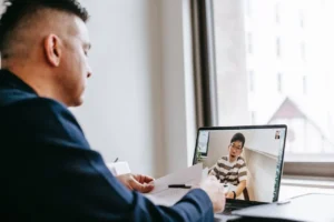 Man working on a laptop and tools, symbolizing business ideas for men to earn from their skills